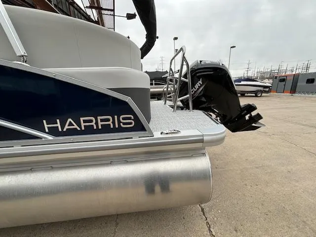 Slide: The Image of 2024 Harris Cruiser 210 CWDH pontoon boat with Mercury outboard motor. - 2