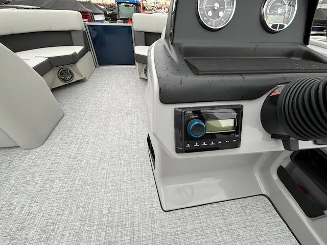 Slide: The Image of 2024 Harris Cruiser 210 CWDH boat interior with dashboard and seating. - 20