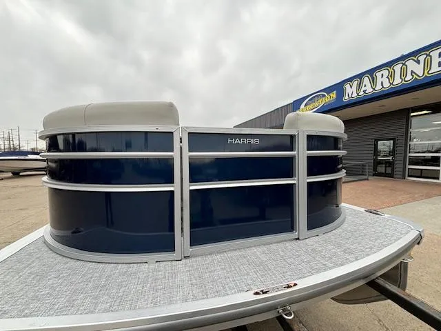 Slide: The Image of 2024 Harris Cruiser 210 CWDH pontoon boat at a marine dealership. - 7