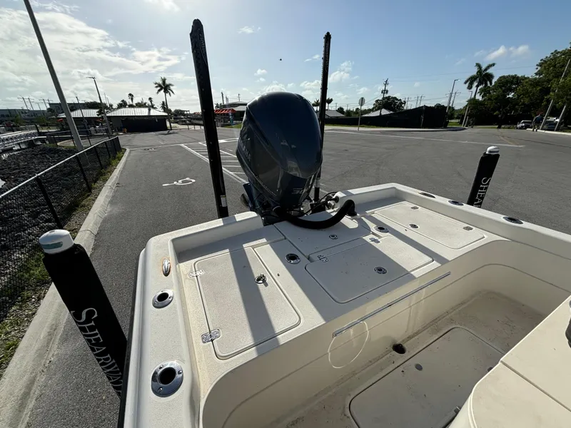 Slide: The Image of 2014 ShearWater 25LTZ boat at dock, featuring a powerful outboard motor. - 11