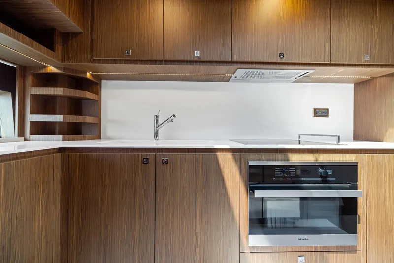 Slide: The Image of Modern kitchen in 2016 Riva 88' Domino Super yacht with wood cabinetry and built-in appliances. - 45