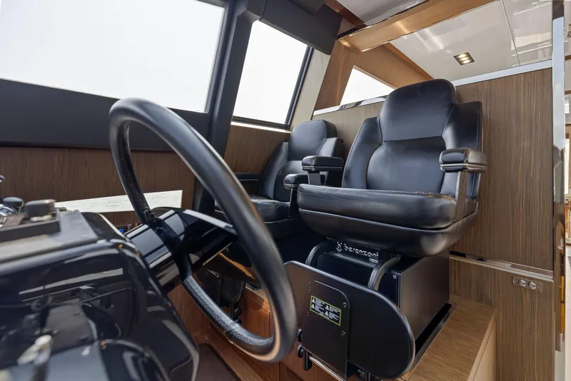 Slide: The Image of Interior helm station of 2016 Riva 88' Domino Super yacht with leather captain chairs. - 40
