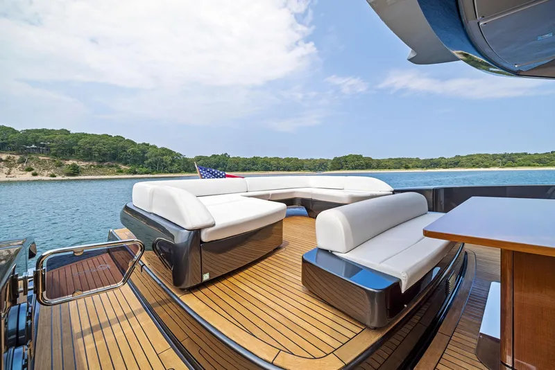 Slide: The Image of Luxury deck of 2016 Riva 88' Domino Super yacht with white seating and scenic water view. - 23