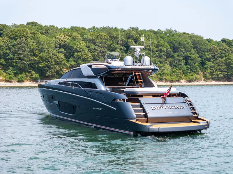 Slide: The Image of Luxury 2016 Riva 88' Domino Super yacht cruising near a forested shoreline. - 3