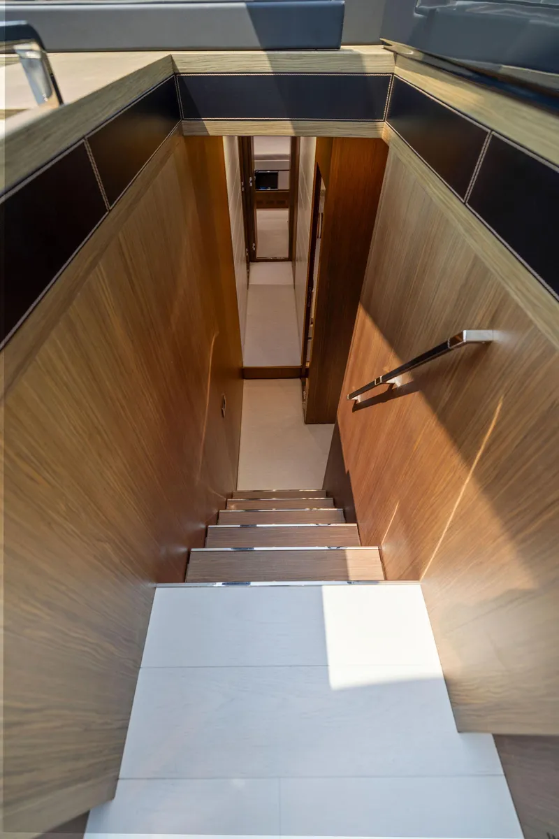 Slide: The Image of Staircase inside 2016 Riva 88' Domino Super yacht with wooden paneling. - 46