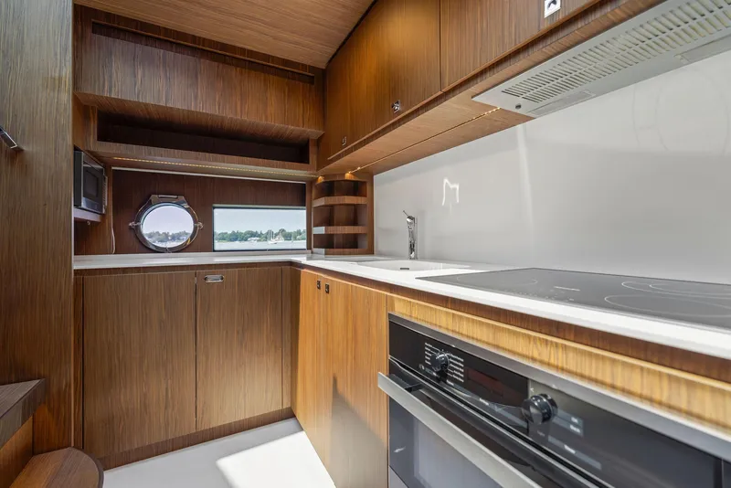 Slide: The Image of Modern kitchen interior of 2016 Riva 88' Domino Super yacht with wooden cabinetry. - 42