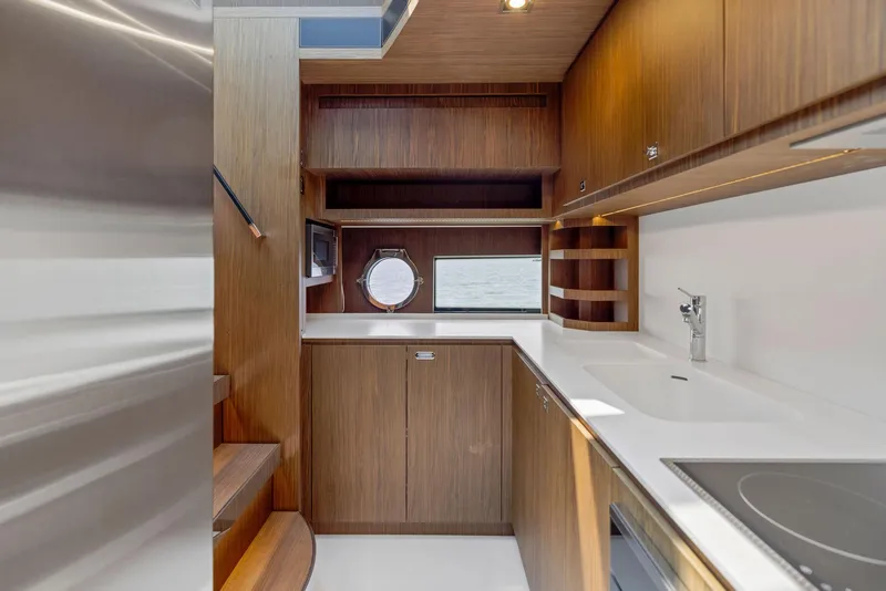 Slide: The Image of Modern kitchen interior of 2016 Riva 88' Domino Super yacht with wooden cabinetry. - 44