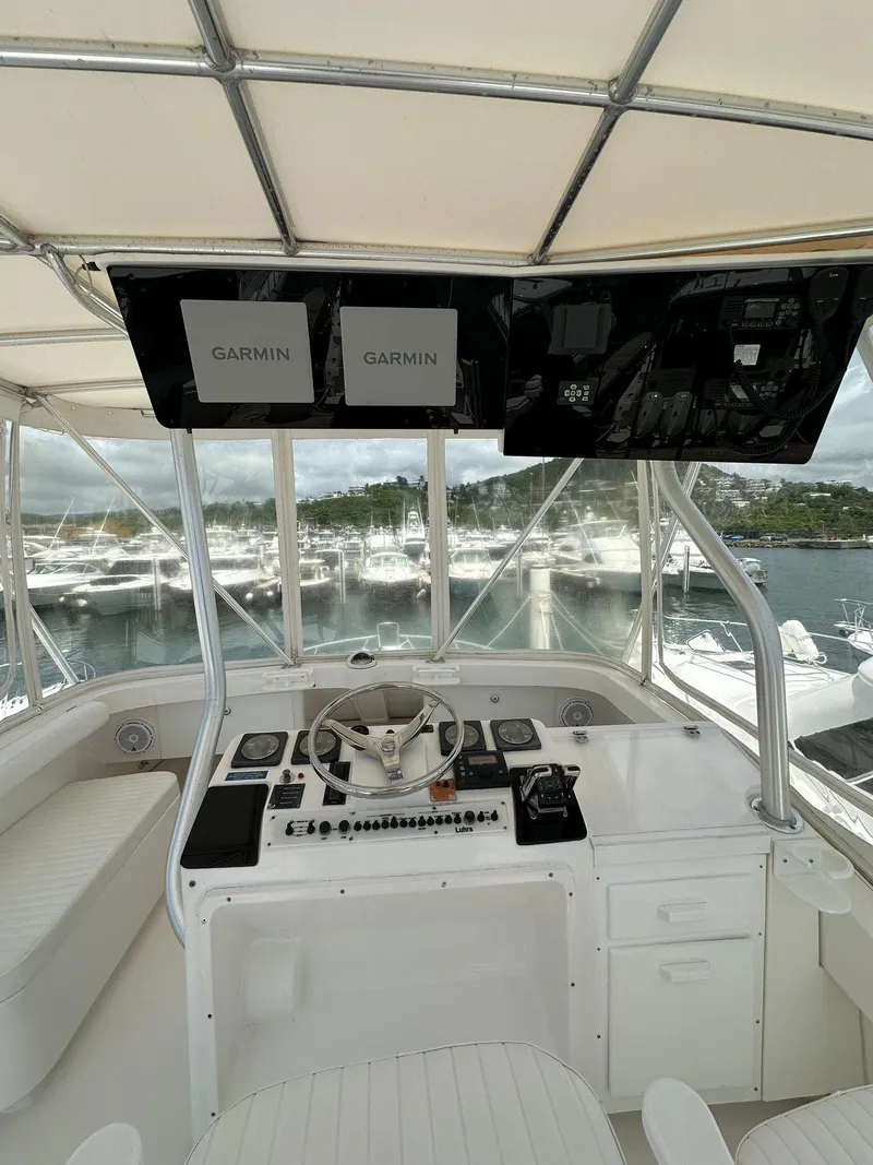 Slide: The Image of 2005 Luhrs 38 Convertible helm with Garmin displays and marina view. - 10