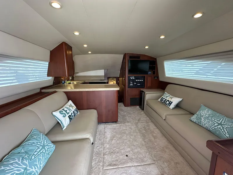 Slide: The Image of Interior of 2005 Luhrs 38 Convertible yacht with modern seating and kitchen area. - 3