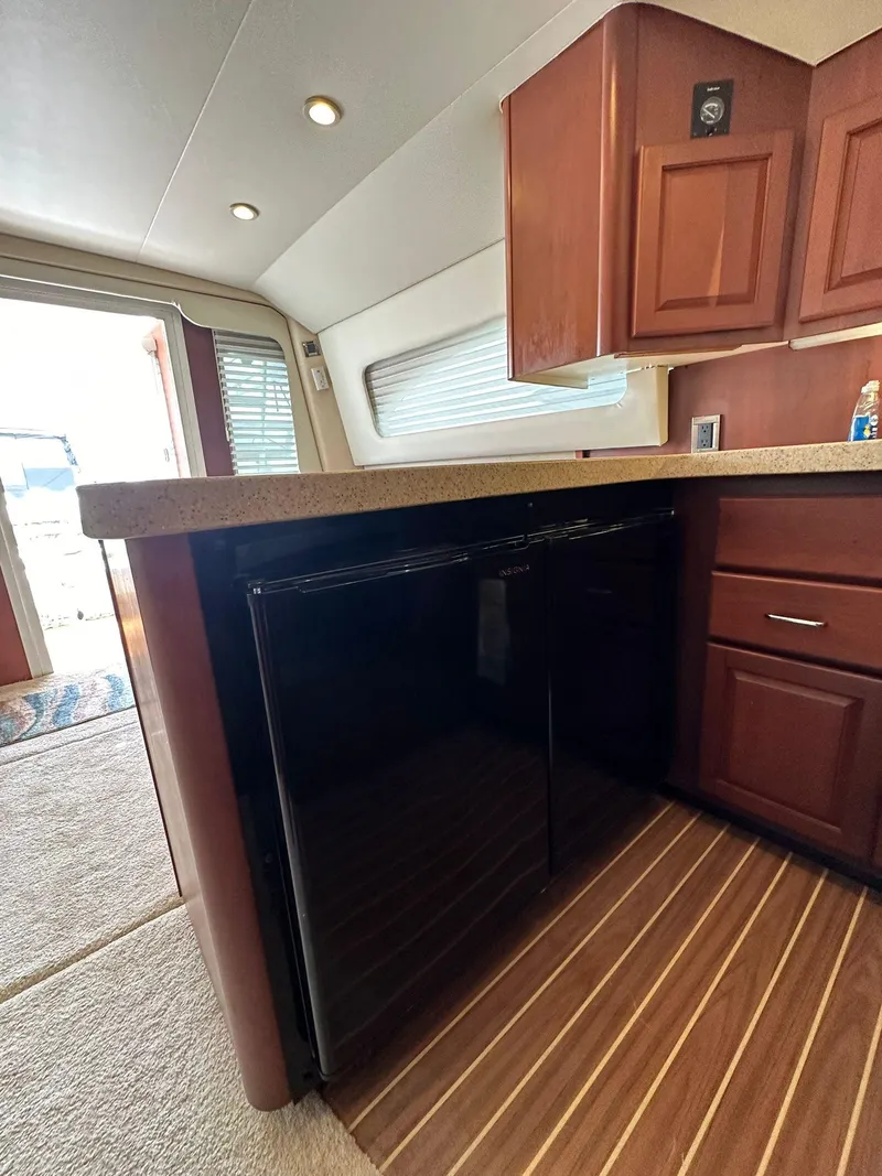 Slide: The Image of 2005 Luhrs 38 Convertible yacht interior with wood cabinetry and flooring. - 6