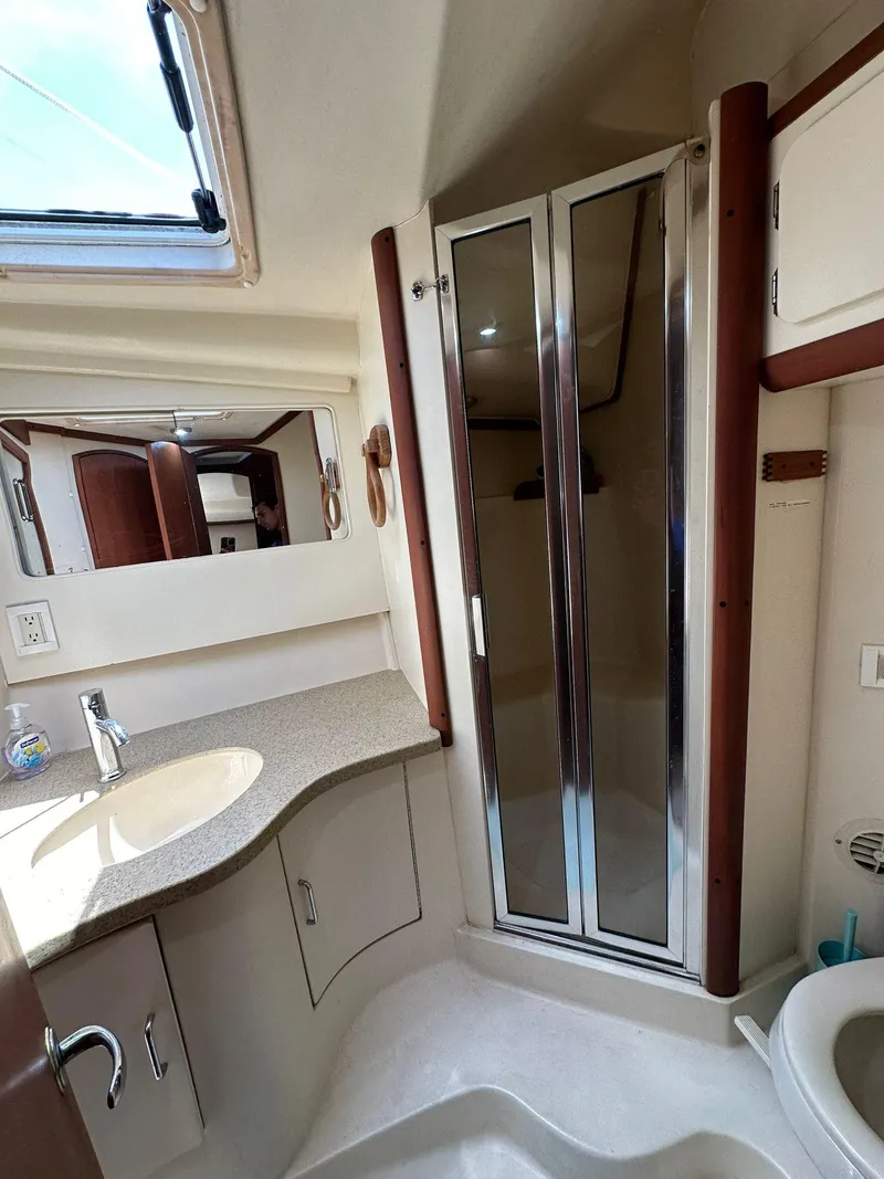 Slide: The Image of 2005 Luhrs 38 Convertible yacht bathroom with shower, sink, and mirror. - 8