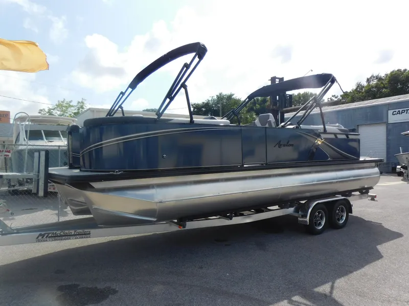Slide: The Image of 2024 Avalon LSZ Quad Lounger pontoon boat on a trailer. - 0