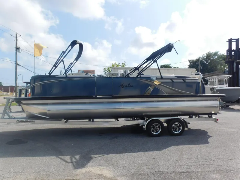 Slide: The Image of 2024 Avalon LSZ Quad Lounger pontoon boat on a trailer. - 1