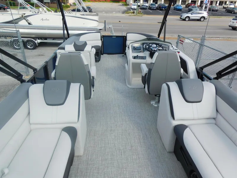 Slide: The Image of 2024 Avalon LSZ Quad Lounger pontoon boat interior with luxurious seating and modern helm. - 10
