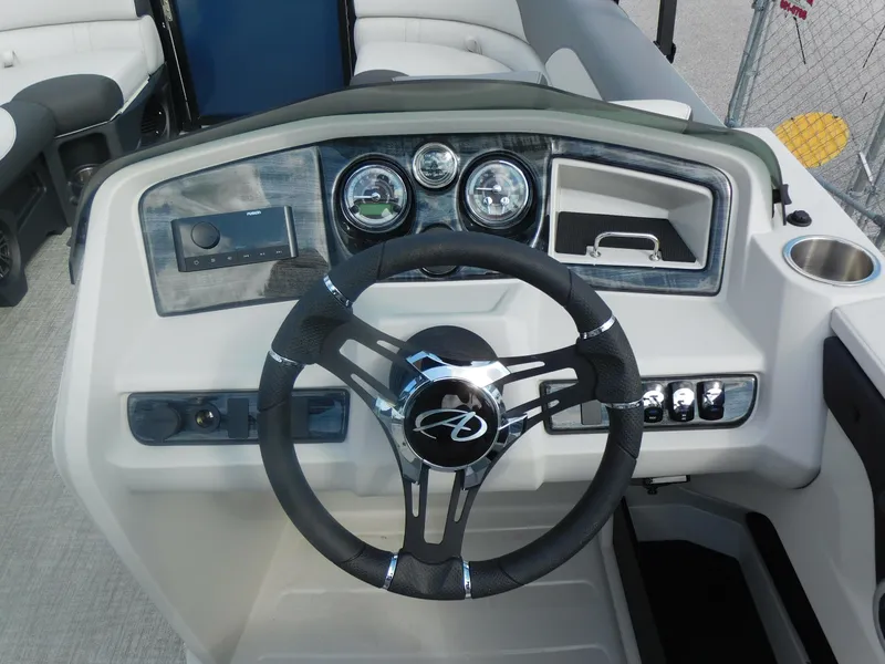 Slide: The Image of 2024 Avalon LSZ Quad Lounger boat dashboard with steering wheel and control panel. - 17