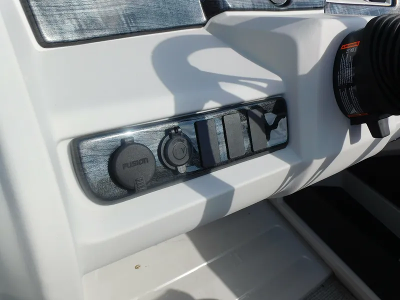 Slide: The Image of Control panel of 2024 Avalon LSZ Quad Lounger boat with switches and ports. - 20