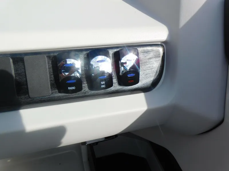 Slide: The Image of Control panel of 2024 Avalon LSZ Quad Lounger with radio, NAV/ANC, and horn buttons. - 21