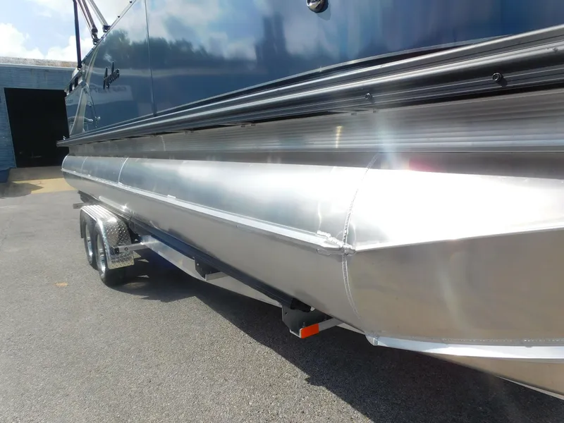 Slide: The Image of 2024 Avalon LSZ Quad Lounger pontoon boat on trailer, side view. - 4