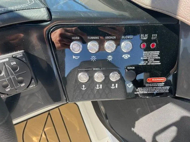 Slide: The Image of Control panel of a 2024 Sea Ray SLX 260 boat with various switches and indicators. - 15