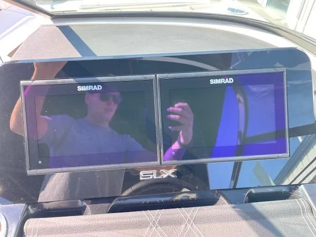Slide: The Image of 2024 Sea Ray SLX 260 dashboard with dual Simrad displays. - 16