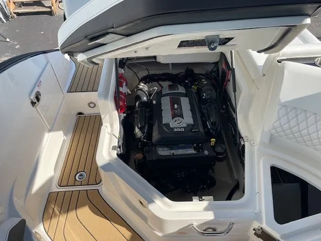 Slide: The Image of 2024 Sea Ray SLX 260 boat engine compartment with open hatch. - 17
