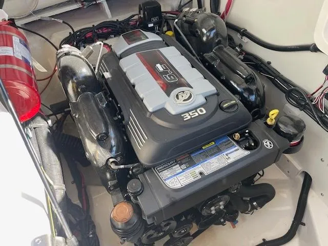 Slide: The Image of 2024 Sea Ray SLX 260 engine compartment with MerCruiser 350 engine. - 18