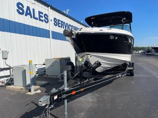 Slide: The Image of 2024 Sea Ray SLX 260 boat on trailer at sales and service center. - 2