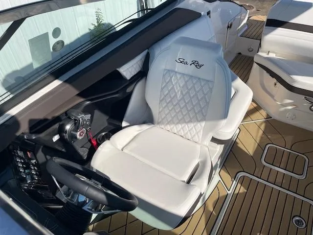 Slide: The Image of 2024 Sea Ray SLX 260 boat interior with white captain's seat and modern dashboard. - 7