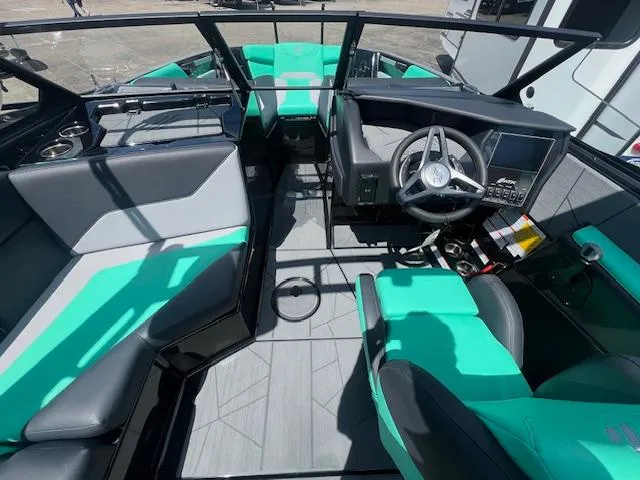 Slide: The Image of 2024 ATX Surf Boats 22 Type-S interior with teal and gray seating, modern dashboard, and spacious layout. - 13