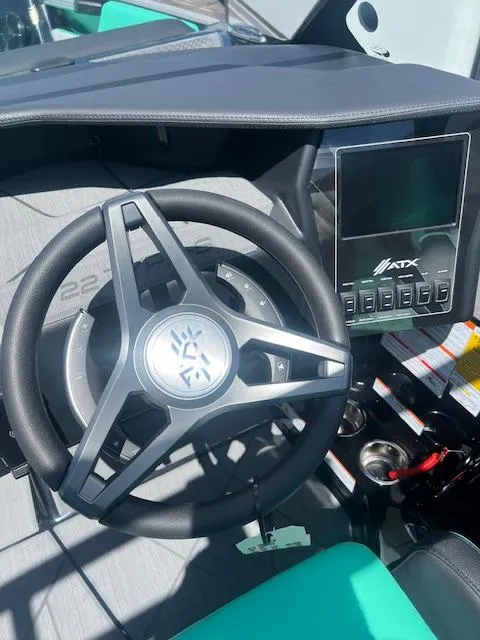 Slide: The Image of 2024 ATX Surf Boats 22 Type-S steering wheel and dashboard. - 16
