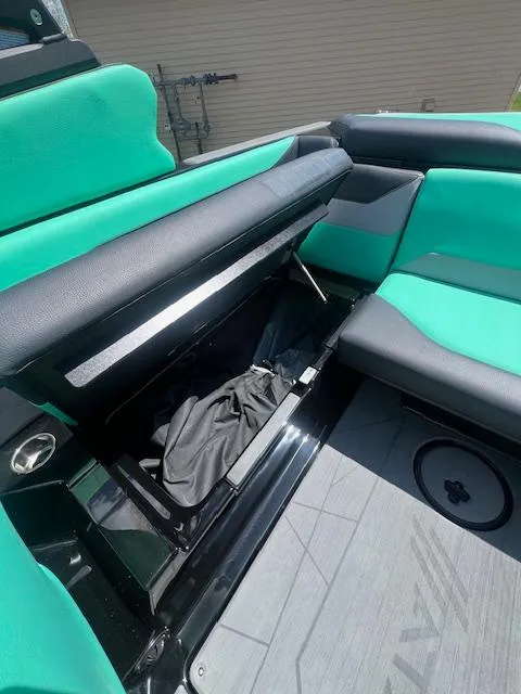 Slide: The Image of 2024 ATX Surf Boats 22 Type-S interior seating and storage compartment. - 21