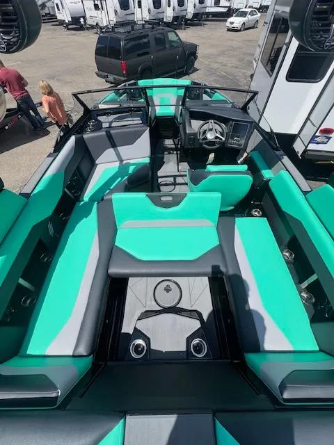 Slide: The Image of 2024 ATX Surf Boats 22 Type-S interior with teal and gray seating. - 22