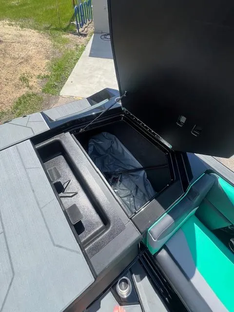 Slide: The Image of 2024 ATX Surf Boats 22 Type-S storage compartment with open lid. - 23