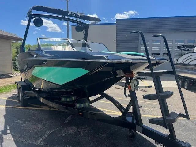 Slide: The Image of 2024 ATX Surf Boats 22 Type-S on trailer, black and green, parked outdoors. - 4