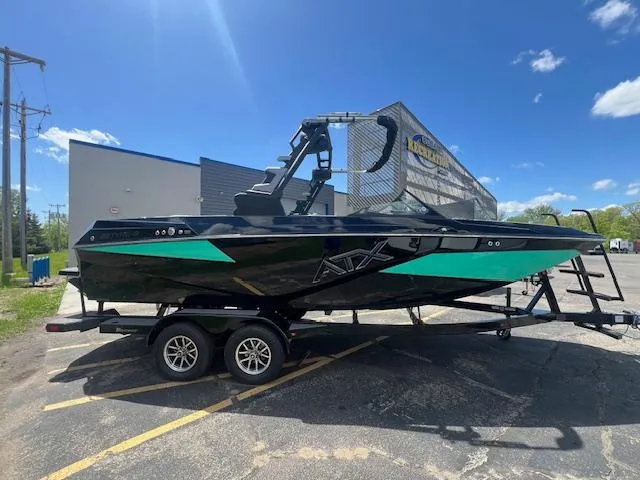 Slide: The Image of 2024 ATX Surf Boats 22 Type-S in black and teal on a trailer. - 5