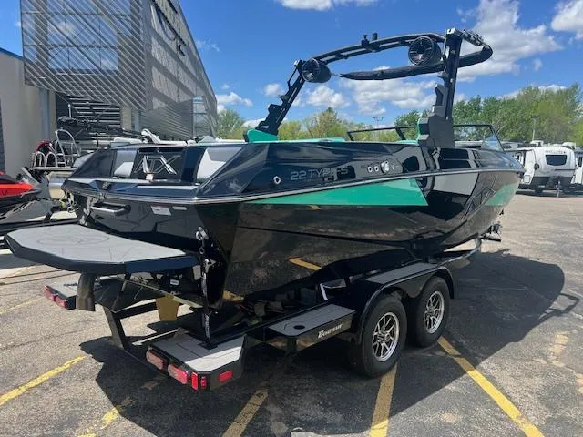 Slide: The Image of 2024 ATX Surf Boats 22 Type-S on trailer, black and green, rear view. - 6