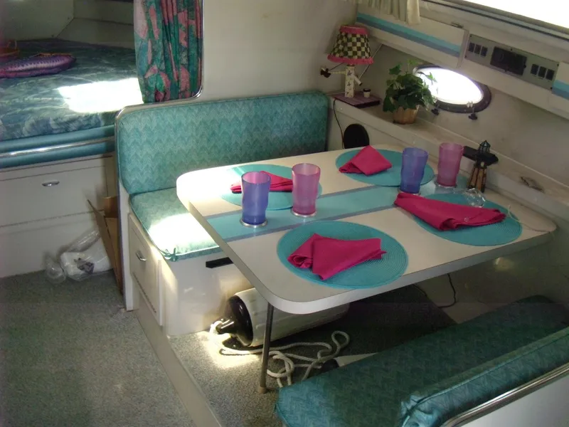 Slide: The Image of Interior of 1988 Wellcraft St. Tropez 3200 with dining area and table settings. - 14
