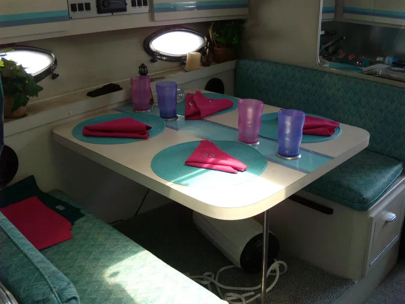 Slide: The Image of 1988 Wellcraft St. Tropez 3200 interior dining area with teal seating and table setup. - 17