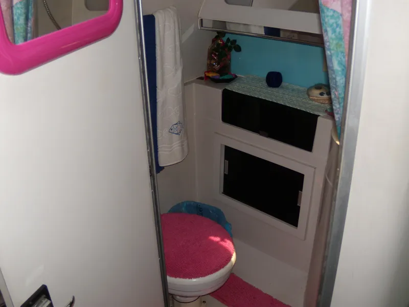 Slide: The Image of 1988 Wellcraft St. Tropez 3200 boat bathroom with pink and blue decor. - 19