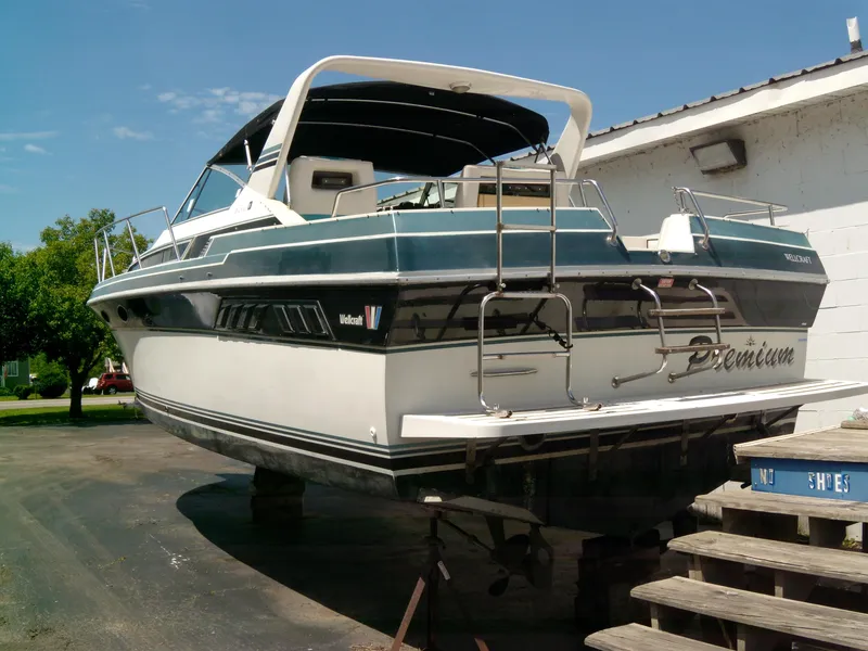 Slide: The Image of 1988 Wellcraft St. Tropez 3200 boat on dry dock, rear view. - 3