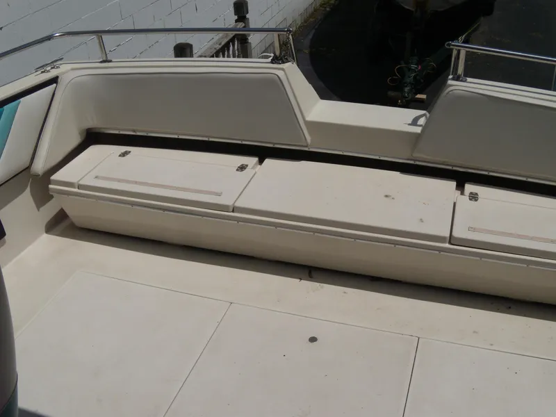 Slide: The Image of 1988 Wellcraft St. Tropez 3200 boat seating area with storage compartments. - 7