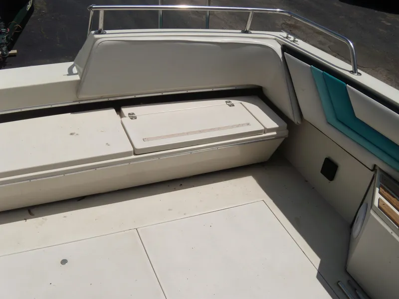 Slide: The Image of 1988 Wellcraft St. Tropez 3200 boat interior seating and storage area. - 8