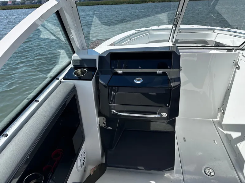 Slide: The Image of 2021 Blackfin 252 DC boat interior with helm station and water view. - 17