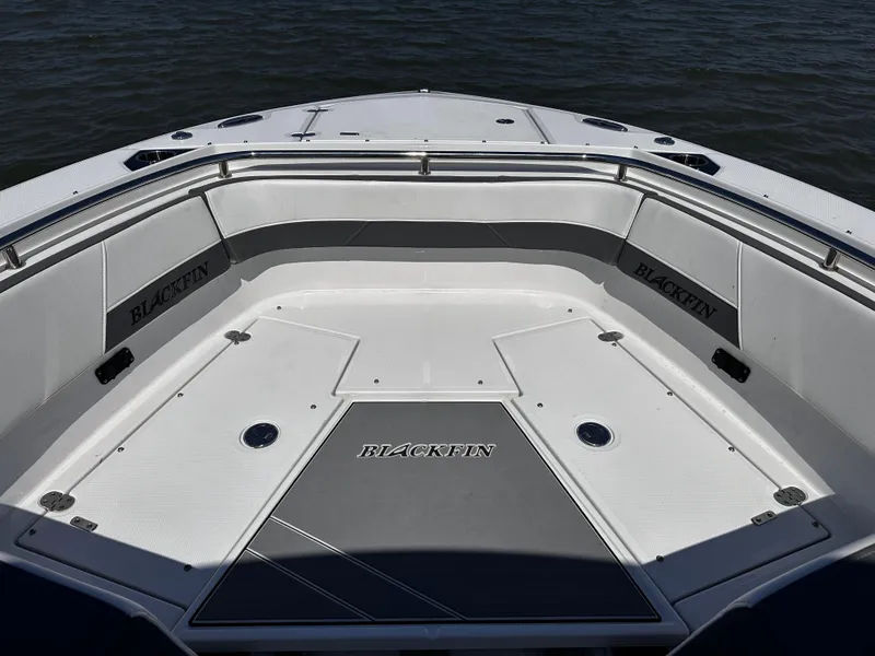 Slide: The Image of 2021 Blackfin 252 DC boat bow seating area with Blackfin branding. - 19
