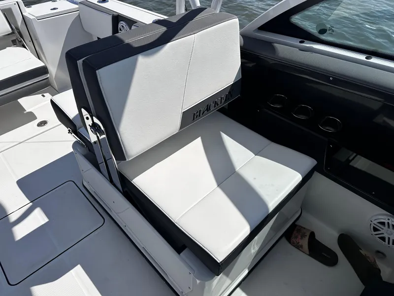 Slide: The Image of 2021 Blackfin 252 DC boat interior with cushioned seating and cup holders. - 21