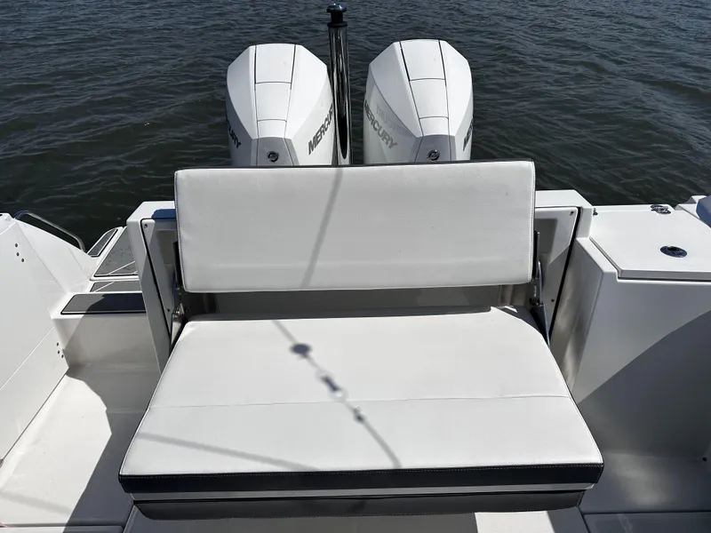 Slide: The Image of 2021 Blackfin 252 DC boat with dual Mercury outboard engines and white cushioned seating. - 25