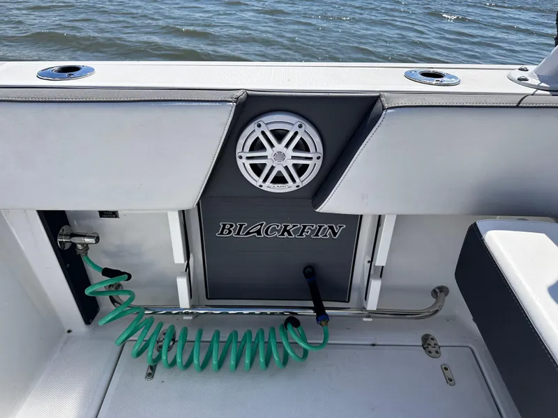 Slide: The Image of 2021 Blackfin 252 DC boat interior with speaker and coiled hose. - 28