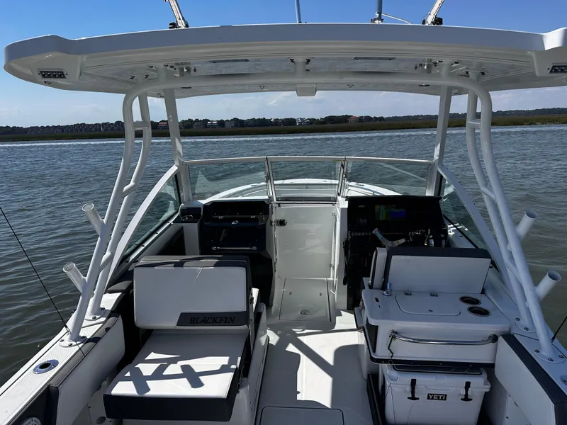 Slide: The Image of 2021 Blackfin 252 DC boat interior with seating and console on the water. - 29