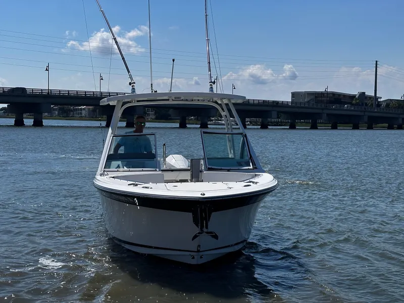 Slide: The Image of 2021 Blackfin 252 DC boat on water near a bridge. - 3