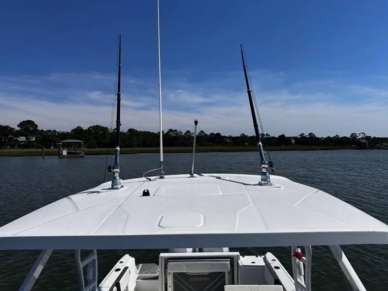 Slide: The Image of 2021 Blackfin 252 DC boat on calm water with clear blue sky. - 30